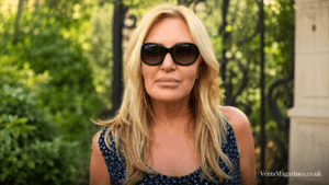 Carol Bryan wearing oversized sunglasses outdoors, standing in front of a softly blurred garden background.