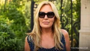 Carol Bryan wearing oversized sunglasses outdoors, standing in front of a softly blurred garden background.
